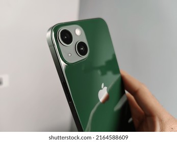 Apple IPhone 13 Back Side Focused On Camera And Logo, This Is Green Unit Holding In Hand.