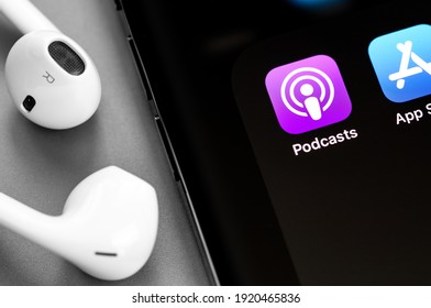 Apple iPhone with Podcasts, App Store icons app on screen and Earpods headphones. Apple Inc. is an American multinational technology company. Moscow, Russia - January 15, 2021