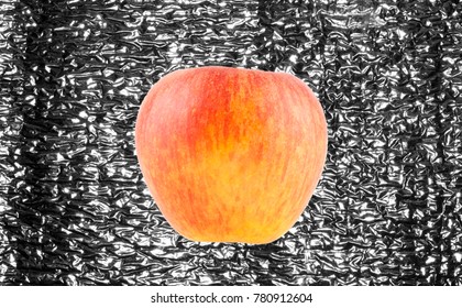 apple isolated on a bent metal background