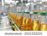 apple juice in glass bottles in a factory for the food industry - bottling and transport 