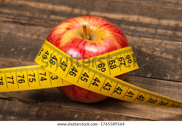 Apple with measuring tape, symbolizing\
overweight and metabolic\
syndrome