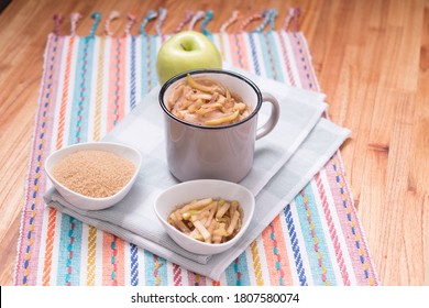 Apple Mug Cake With Ingredients And Sliced Apple On Top Over Wood