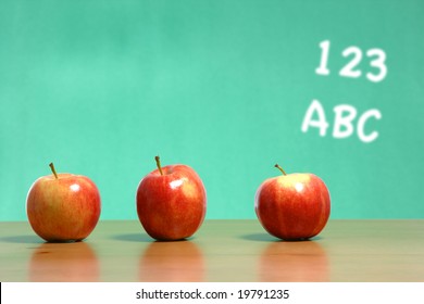 An apple on a desk in a classroom