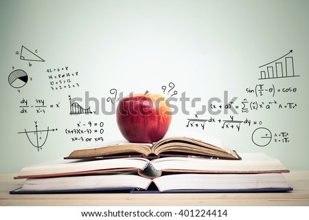 Apple on stack of open books with education doodles and copy space. Education concept.
