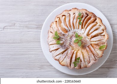 Apple Pie With Cinnamon And Mint Close Up On The Table. Horizontal Top View  