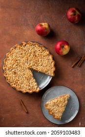 Apple pie with cinnamon shortcrust pastry on a dark brown background. - Shutterstock ID 2059103483