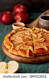 Apple Pie, Galette With Fruits, Sweet Pastries On Dark Green Tablecloth, Sweet Crostata On Cutting Wooden Board, Side View, Autumn Or Winter Food, Vertical