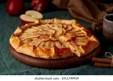 Apple Pie, Galette With Fruits, Sweet Pastries On Dark Green Tablecloth, Sweet Crostata On Cutting Wooden Board, Side View, Autumn Or Winter Food, Close Up, Side View