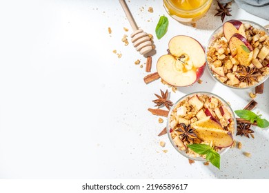 Apple Pie Granola Cheesecake, breakfast snack layered dessert with oat granola, cream cheese yogurt, honey, apple slices and cinnamon spices on white background copy space - Powered by Shutterstock