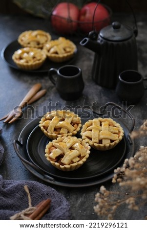 Apple pie on black plate. apple, tea pot and cup, mini fork, napkin and dreid flower as element. Apple Pie