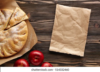 Apple Pie On A Wooden Rustic Table. Top View.  Piece Kraft Paper Empty Space For Text.