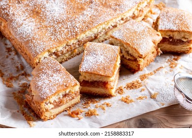 Apple pie slices (traditional Hungarian version) on wooden background - Shutterstock ID 2158883317