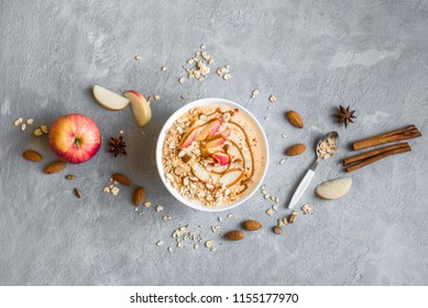 Apple Pie Smoothie Bowl. Breakfast Smoothie Bowl With Apples, Cinnamon, Almond Milk, Oat Granola, Salted Caramel And Spices, Top View.