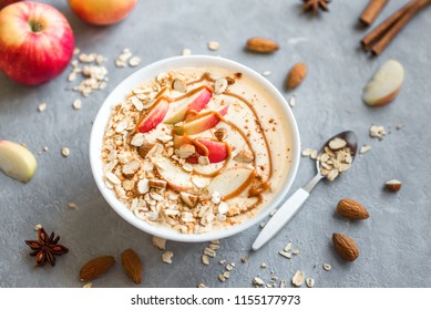 Apple Pie Smoothie Bowl. Breakfast Smoothie Bowl With Apples, Cinnamon, Almond Milk, Oat Granola, Salted Caramel And Spices, Top View.