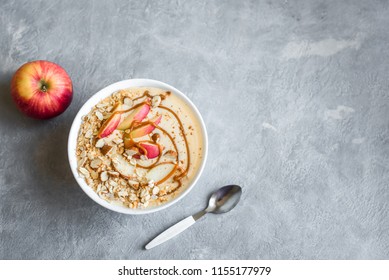 Apple Pie Smoothie Bowl. Breakfast Smoothie Bowl With Apples, Cinnamon, Almond Milk, Oat Granola, Salted Caramel And Spices, Top View, Copy Space.