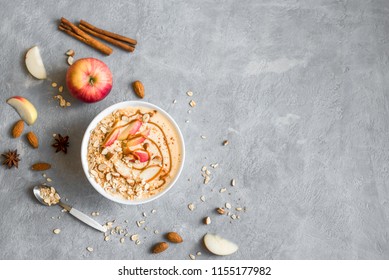 Apple Pie Smoothie Bowl. Breakfast Smoothie Bowl With Apples, Cinnamon, Almond Milk, Oat Granola, Salted Caramel And Spices, Top View, Copy Space.