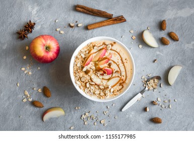 Apple Pie Smoothie Bowl. Breakfast Smoothie Bowl With Apples, Cinnamon, Almond Milk, Oat Granola, Salted Caramel And Spices, Top View, Copy Space.