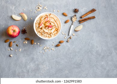 Apple Pie Smoothie Bowl. Breakfast Smoothie Bowl With Apples, Cinnamon, Almond Milk, Oat Granola, Salted Caramel And Spices, Top View, Copy Space.