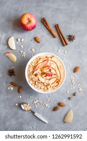 Apple Pie Smoothie Bowl. Breakfast Smoothie Bowl With Apples, Cinnamon, Almond Milk, Oat Granola, Salted Caramel And Spices, Top View, Copy Space.