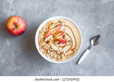 Apple Pie Smoothie Bowl. Breakfast Smoothie Bowl With Apples, Cinnamon, Almond Milk, Oat Granola, Salted Caramel And Spices, Top View, Copy Space.