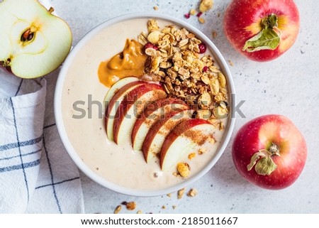 Apple pie smoothie bowl with granola and peanut butter, top view, closeup. Autumn recipe. Vegan food.