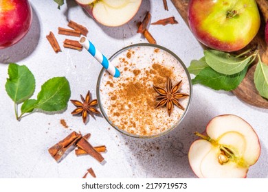 Apple pie smoothie with yogurt, apple slices, oatmeal granola flakes, cinnamon, spices and walnuts. Healthy uatumn breakfast or snack, with fresh raw apples and spices copy space