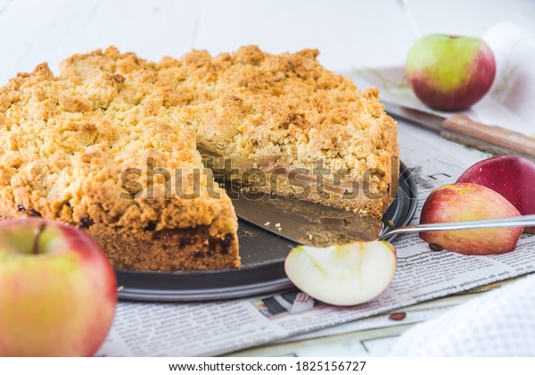 Apple pie with sprinkles, apple crumble, on a\
tray on white background