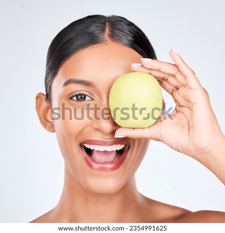 Apple, portrait and skincare of woman in studio for vitamin c benefits, natural cosmetics and nutrition on white background. Face of happy indian model, healthy beauty and green fruits for vegan diet