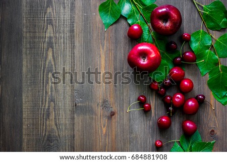 Apple, pulm, cherry for summer fruit drink on wooden table background top view copyspace