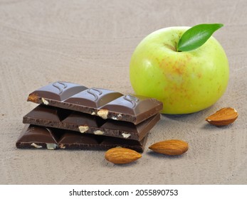 Apple, Ripe, Green. Chocolate With Nuts, Almonds.Isolated On A Vintage Background.Proper Nutrition. For A Vegetarian Menu. Close-up.High-resolution Micrography.For The Restaurant. Synergy Of Products.