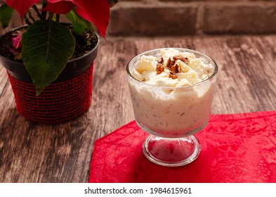 Apple salad with cream. Bowl with apple salad on wooden table with poinsettia. - Powered by Shutterstock