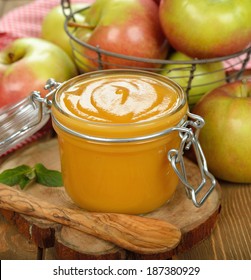 Apple Sauce In A Jar On A Brown Background