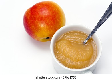 Apple And Sauce With Spoon In A Little Cup