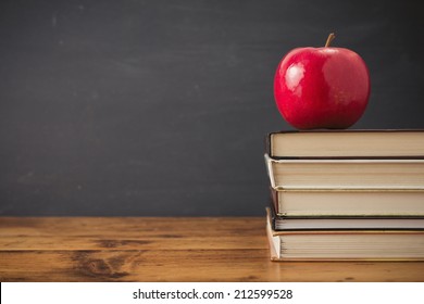 Apple and stack of books - Powered by Shutterstock