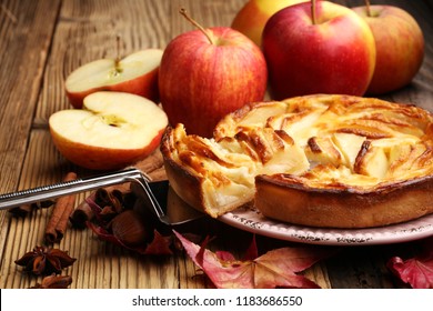 Apple tart. Gourmet traditional holiday apple pie sweet baked dessert food with cinnamon and apples on vintage background. Autumn decor. Rustic style - Powered by Shutterstock