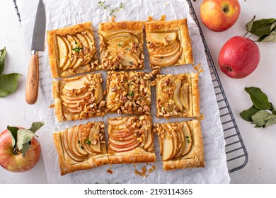 Apple tart with puff pastry topped with sliced apples, walnuts and brown sugar caramel sliced into squares