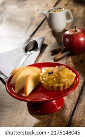 Apple Tartlet With Cinnamon, On A Red Cake Stand, On A Wooden Table