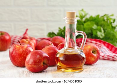 Apple vinegar. Bottle of apple vinegar on wooden background. Healthy food.