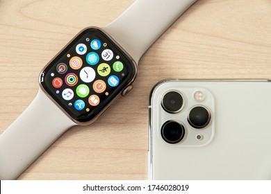 Apple Watch Series 5 with IPHONE 11 Pro on the wooden Plate