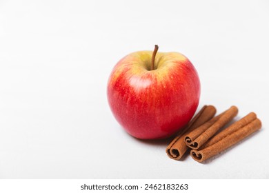 Apples with cinnamon on a textured wooden background. Fragrant red spiced apples with cinnamon sticks and star anise. Apple slices with spicy spices. Place for text. Copy space. Harvesting. Fruits.  - Powered by Shutterstock