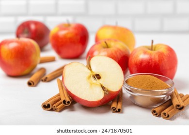 Apples with cinnamon on a textured wooden background. Fragrant red spiced apples with cinnamon sticks and star anise. Apple slices with spicy spices. Place for text. Copy space. Harvesting. Fruits. - Powered by Shutterstock