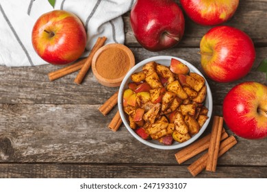 Apples with cinnamon on a textured wooden background. Fragrant red spiced apples with cinnamon sticks and star anise. Apple slices with spicy spices. Place for text. Copy space. Harvesting. Fruits. - Powered by Shutterstock