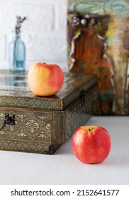 Apples And An Old Jewelry Box On A White Table