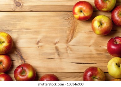 Apples on wooden table background. Fresh fruit backdrop with empty room for text - Powered by Shutterstock