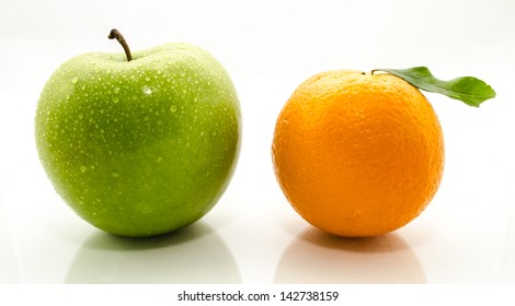 Apples and oranges fresh from the garden isolated white background.