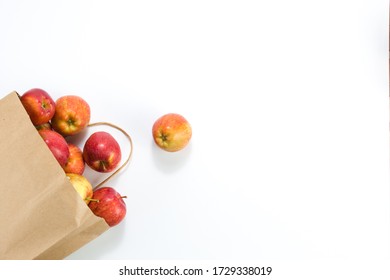 Apples And Pears In A Paper Bag Of Craft Paper On White Background. Free Space For Your Text. Top View