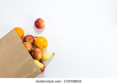 Apples And Pears In A Paper Bag Of Craft Paper On White Background. Free Space For Your Text. Top View.