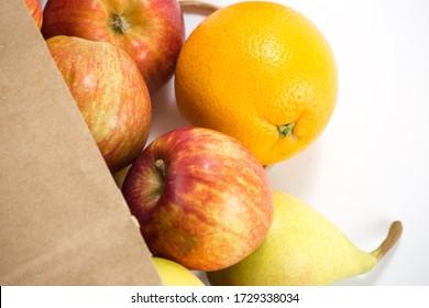 Apples And Pears In A Paper Bag Of Craft Paper On White Background. Free Space For Your Text. Top View.