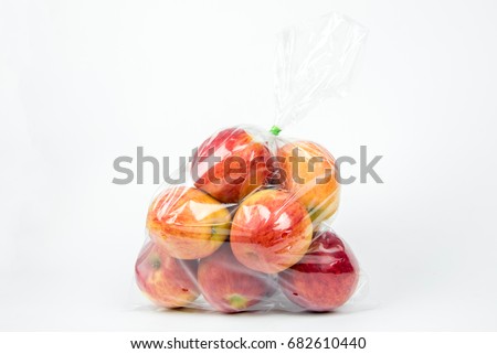 Apples in plastic bag on white background