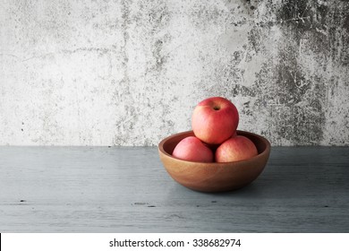 Apples in a wood bowl on wooden background. - Powered by Shutterstock